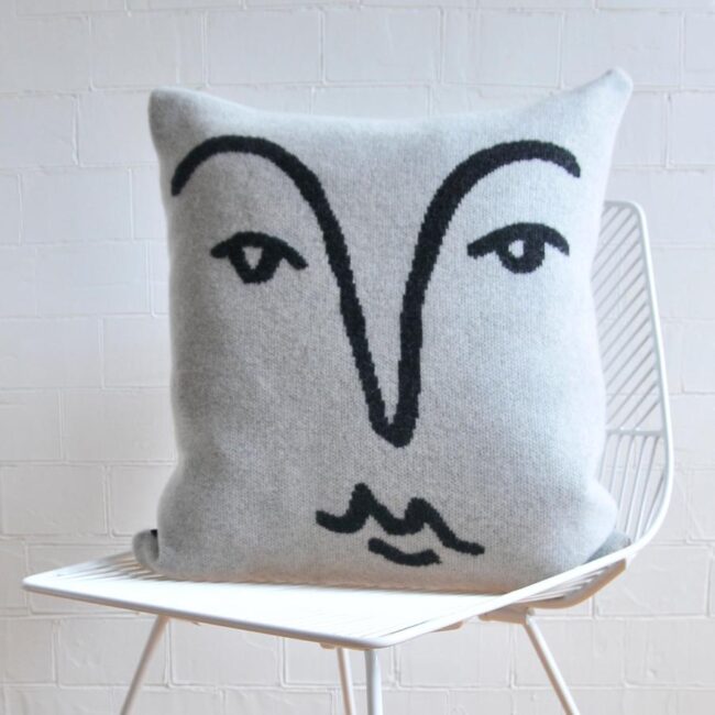Merino wool cushion with face outlined in black